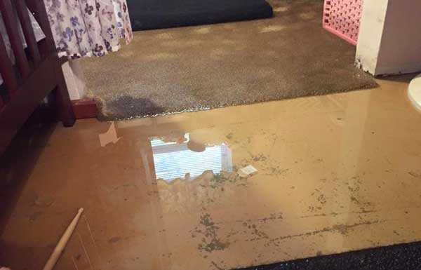 Water piled up on floor that will cause water damage without water extraction